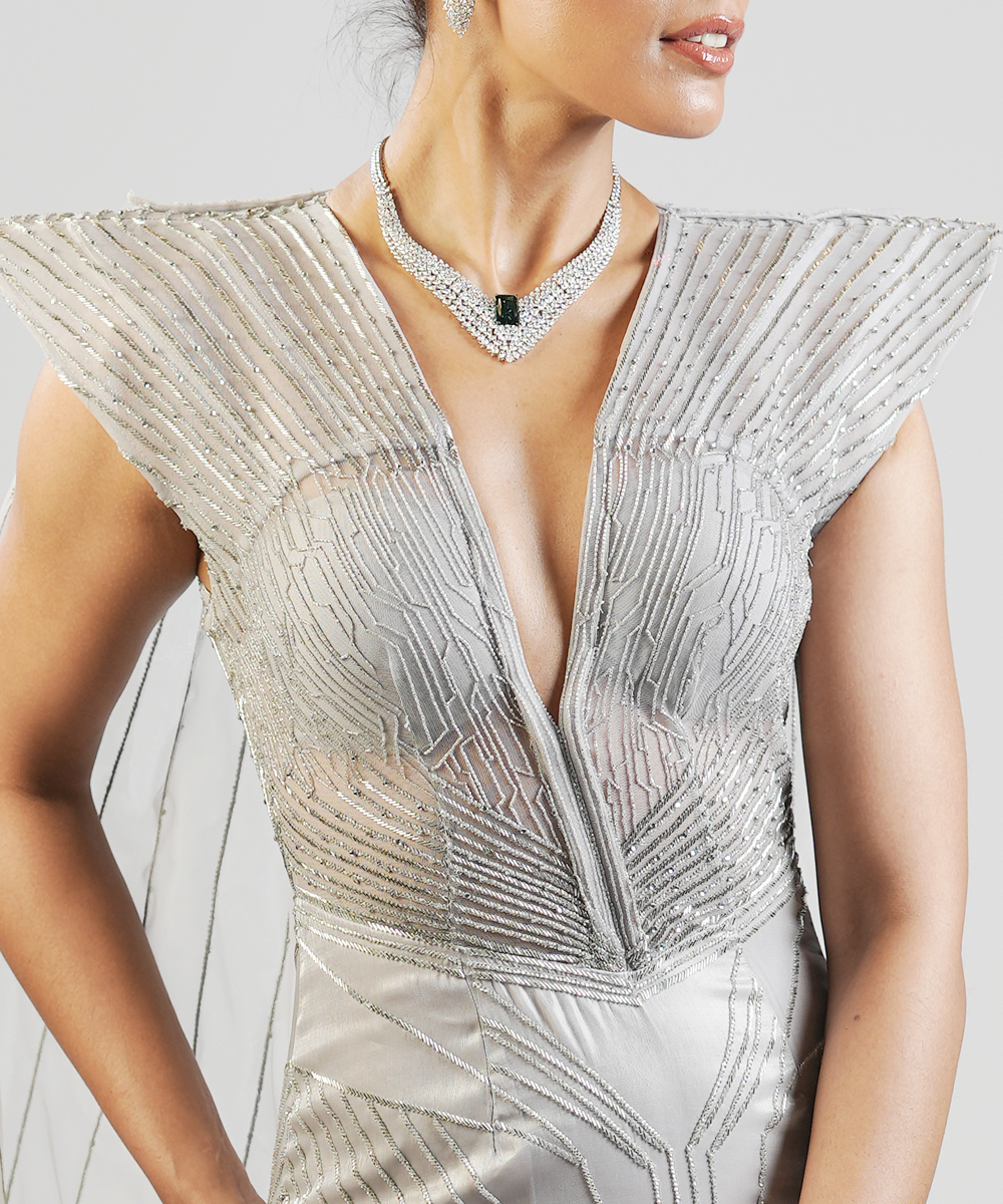 Silver power shoulder gown with cape